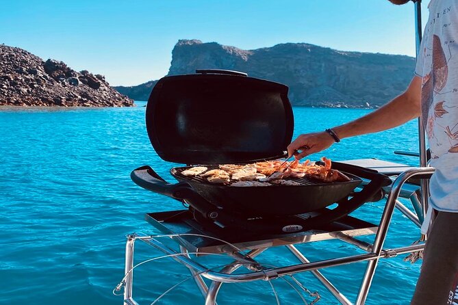 Half-Day Exclusive Catamaran Cruise in Santorini With Meal and Open Bar - Common Questions