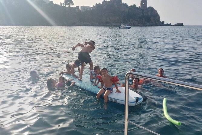 Discovering Cefalùs Coastline Activity on a Mini Catamaran
