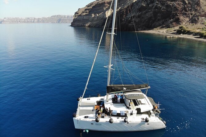 Half-Day Exclusive Catamaran Cruise in Santorini With Meal and Open Bar - Pricing and Booking Options