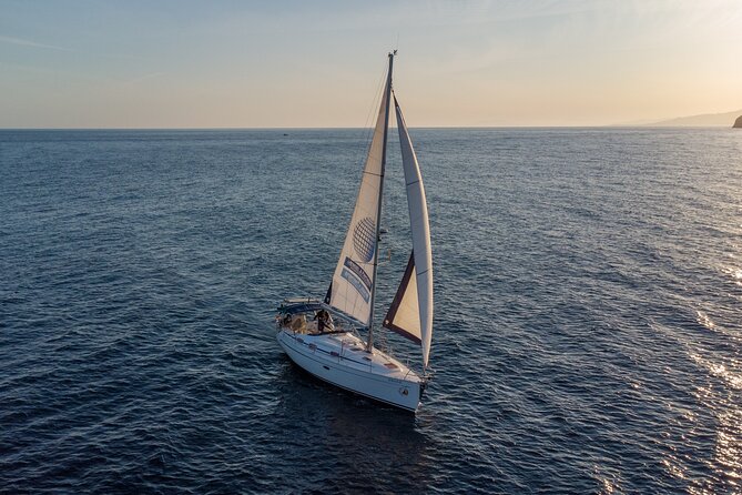 Sailing at sunset along the cliffs of Maro-Compartida - The Value in Price and Booking