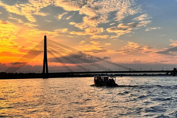Riga: Evening or Sunset Boat Tour with Drink and Audio Guide - The Sum Up