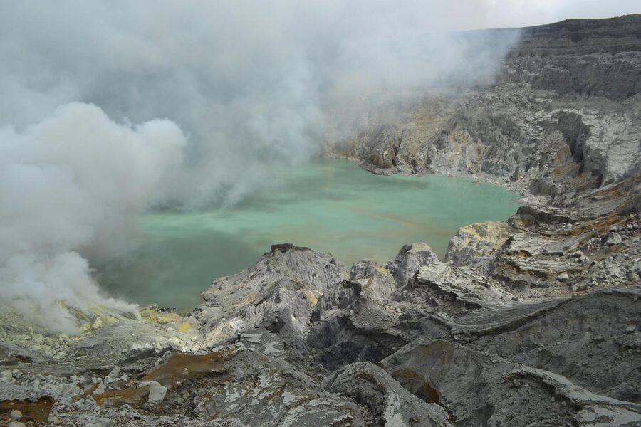 Ijen sulfur miner carrying yellow sulfur blocks