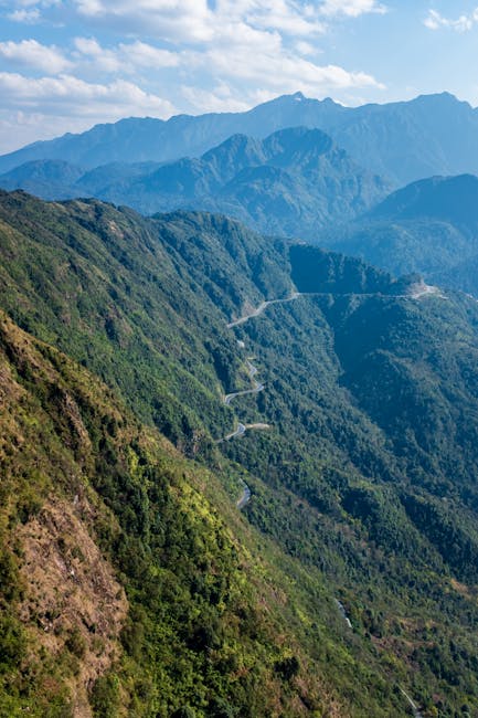 Winding mountain road through lush green hills