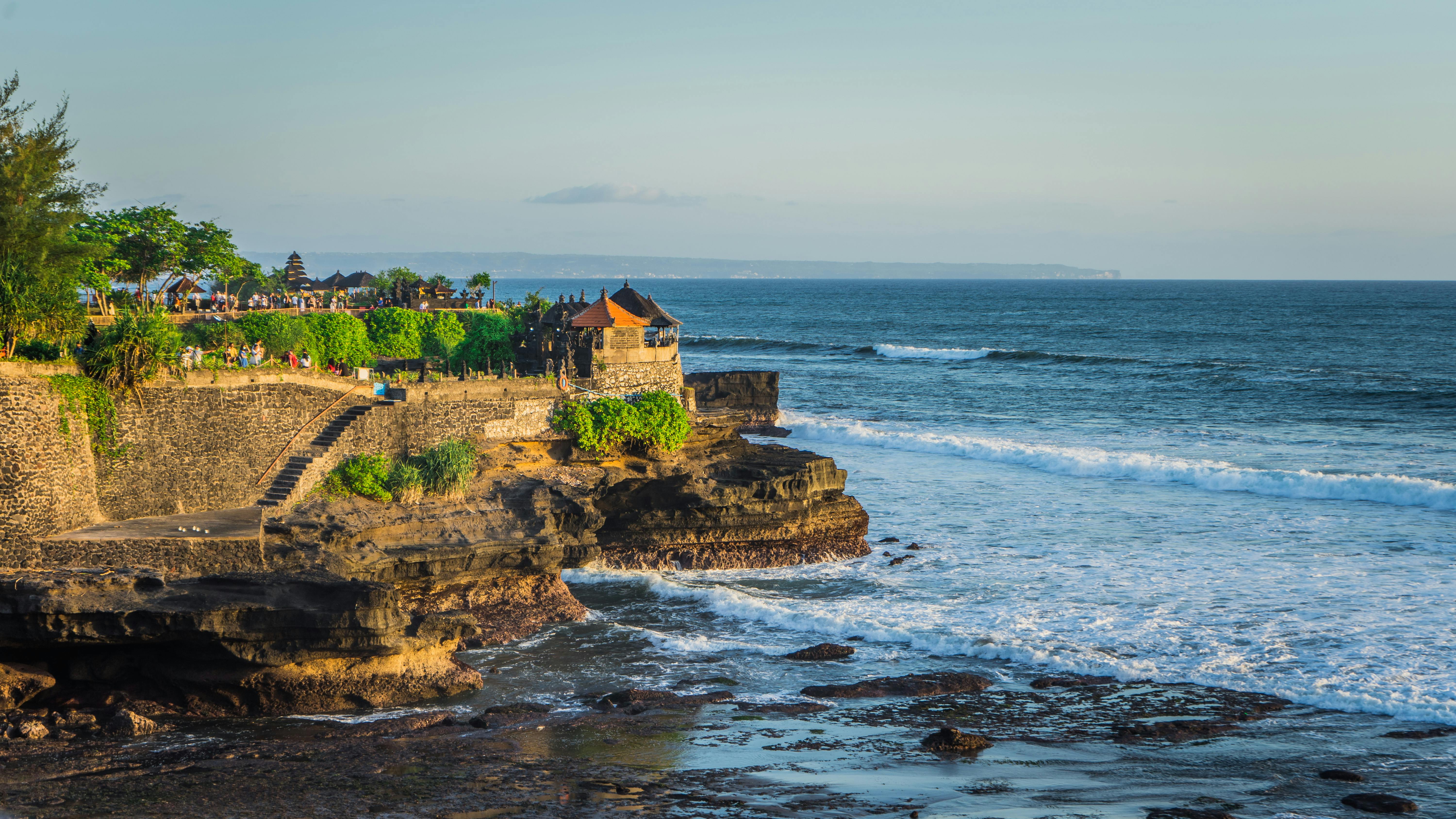Aerial view of Tanah Lot Temple on a rocky outcrop in the sea
