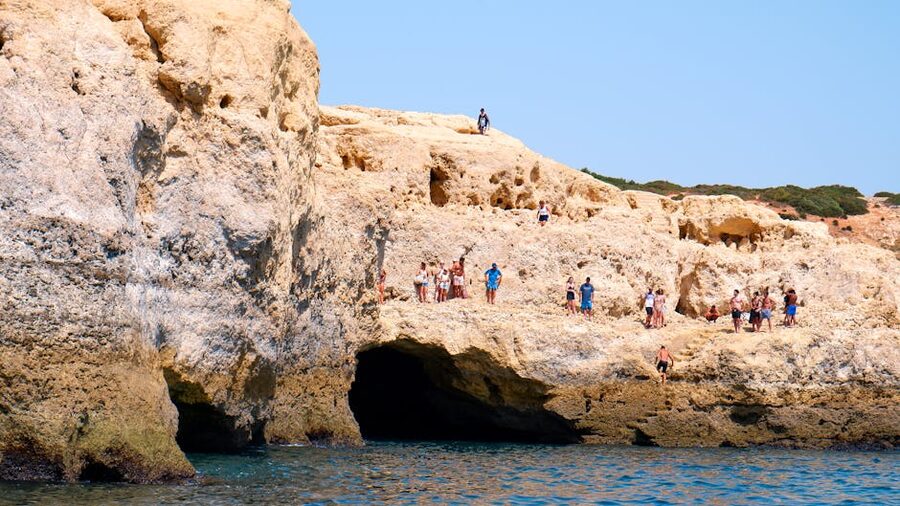 Tourists exploring Algarve cliffs and caves