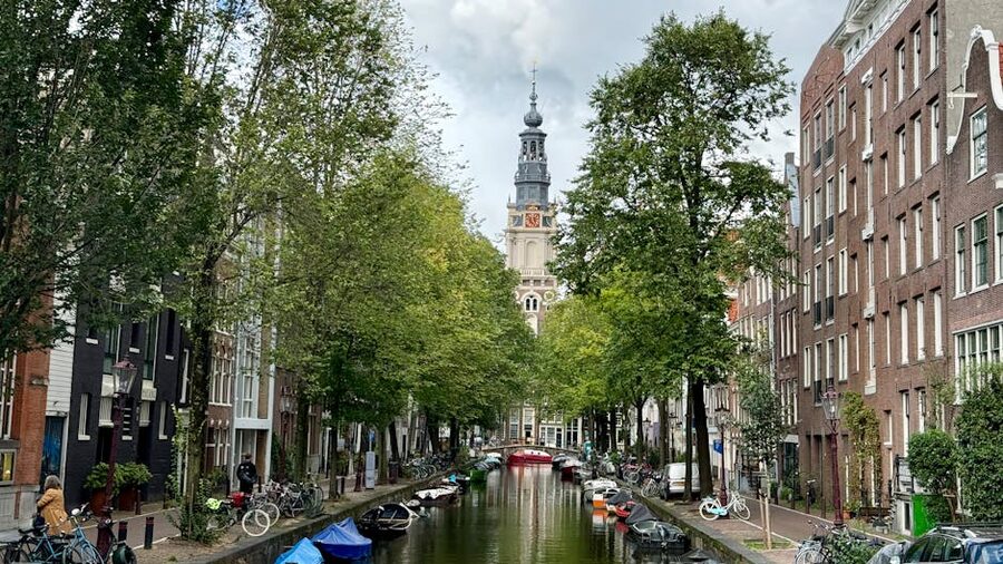 Amsterdam canal with bicycles and Westerkerk in distance