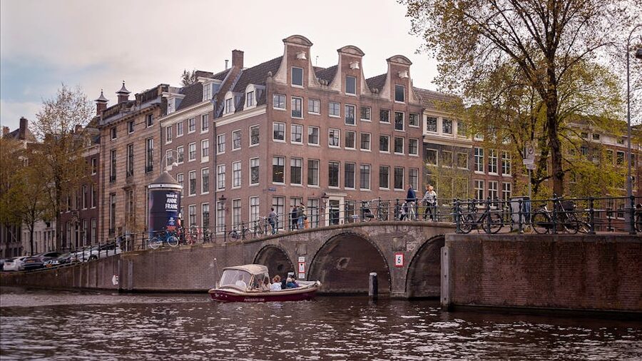 Historic Amsterdam canal with bridge and boat
