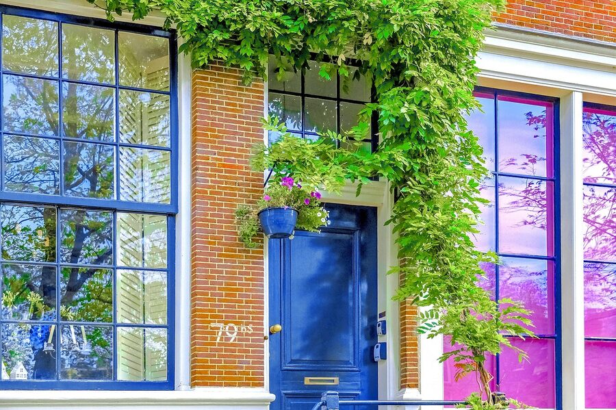 Jordaan brick facade with blue door Amsterdam