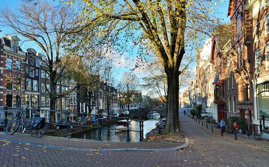 Amsterdam canal autumn bicycles trees