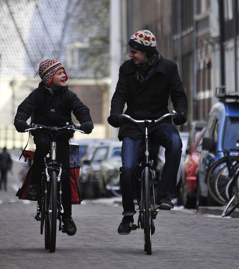 Two brothers cycling in Amsterdam