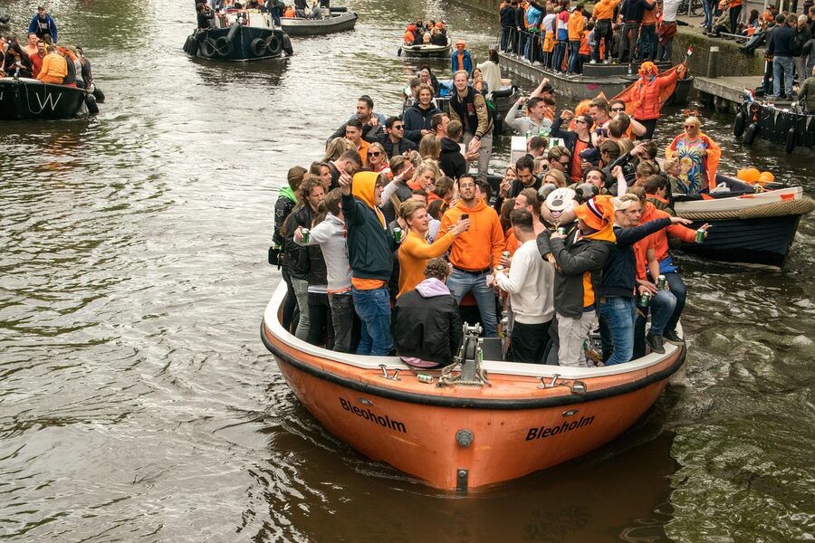 Amsterdam canal celebration boats with crowd