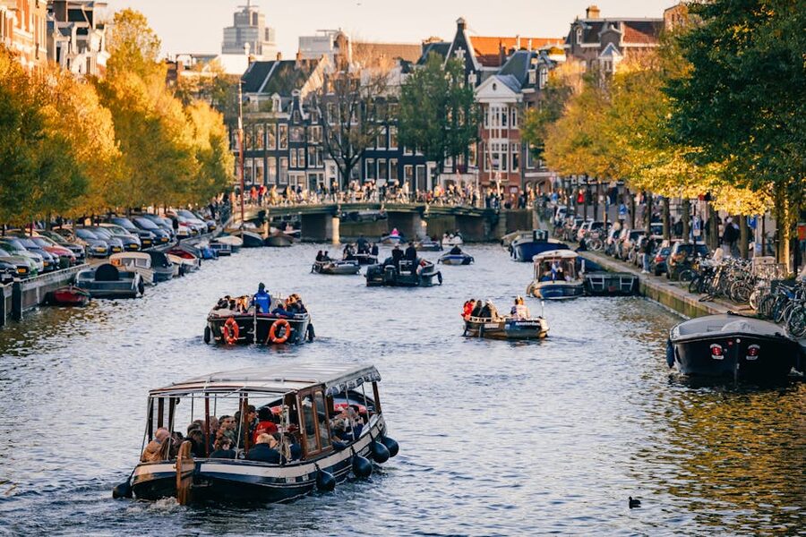 Amsterdam tourists riding canal boats