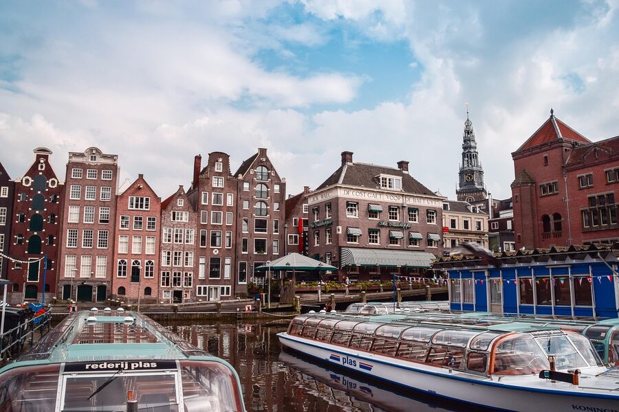 Amsterdam canal port with boats and traditional houses