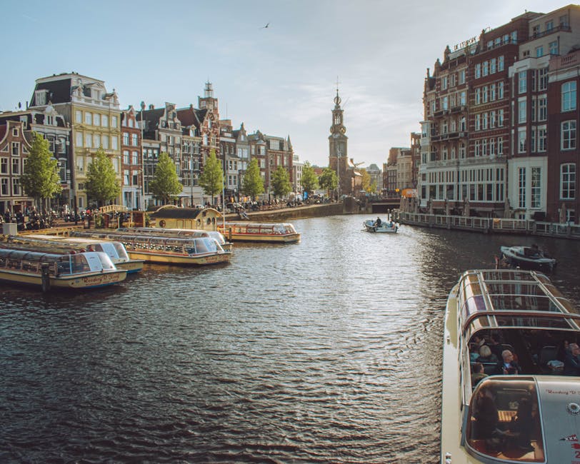 Amstel canal view with Westerkerk church spire Amsterdam