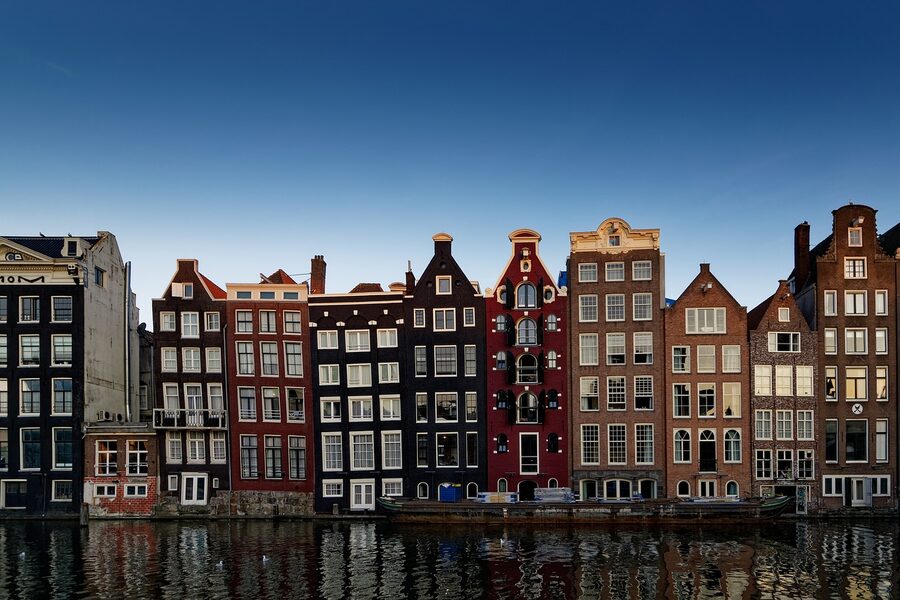 Amsterdam canal houses lining the river