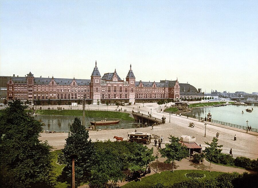 Amsterdam Centraal Station facade with the HOHO bus and boat hub out front