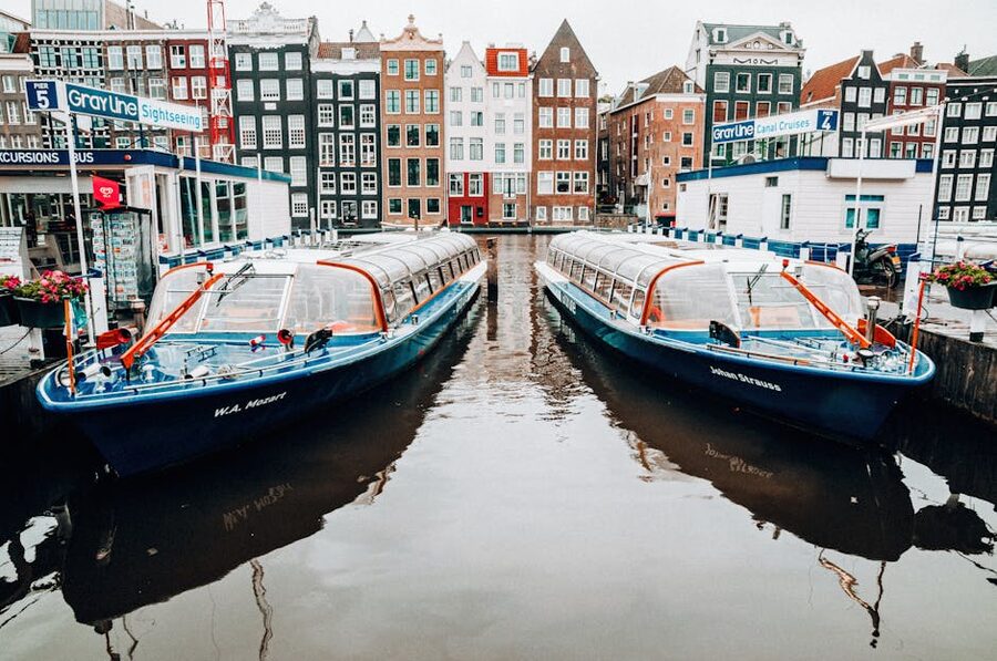 Tour boats docked along an Amsterdam canal