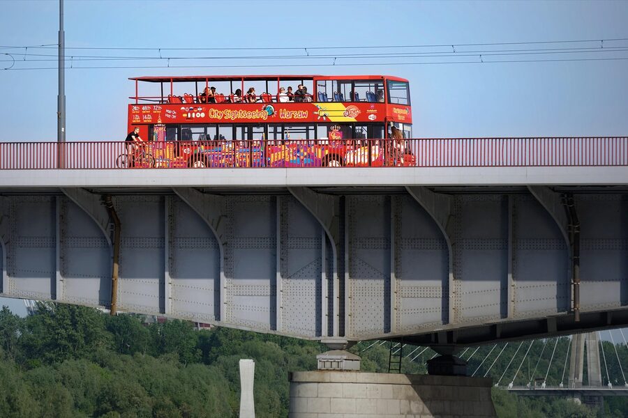 Sightseeing tour bus crossing a city bridge