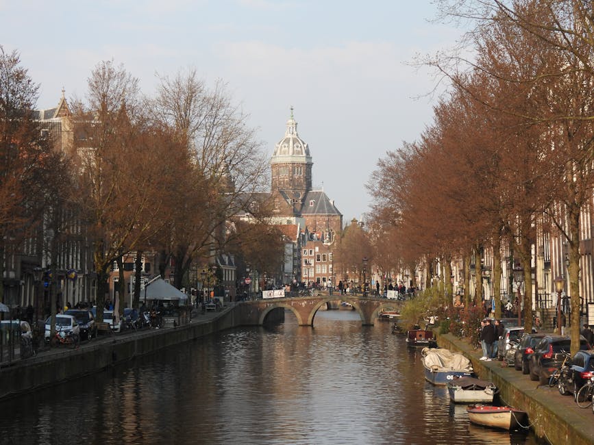 Amsterdam canal with historic buildings near XtraCold