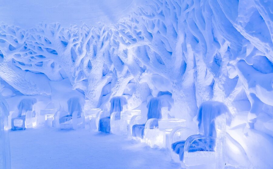 Blue lit ice bar interior with carved seating