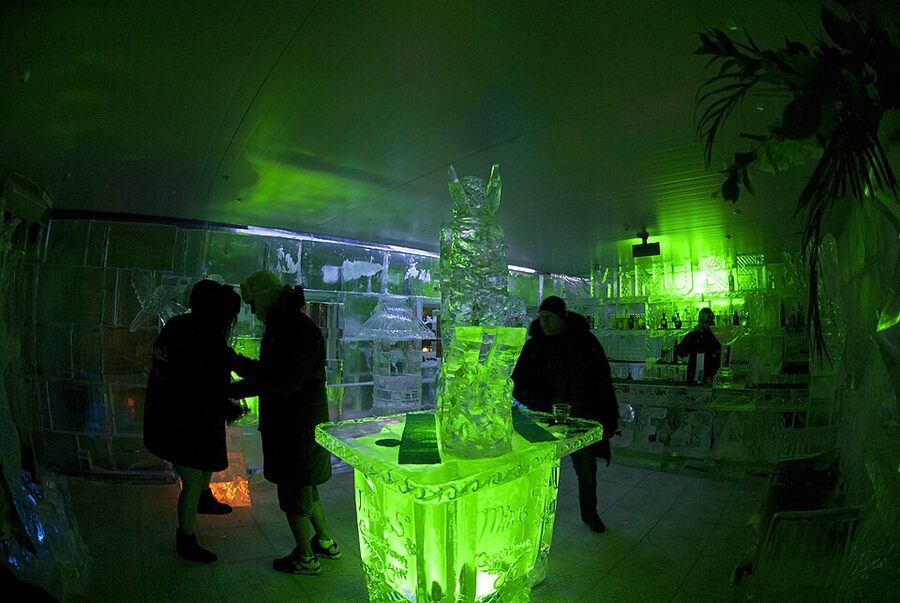 Carved ice glasses lined up on icebar counter