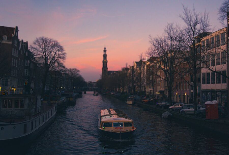 Open boat at sunset on an Amsterdam canal