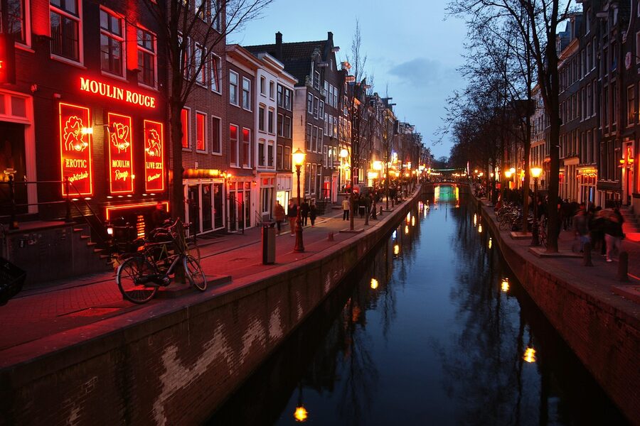Amsterdam Red Light District street in the evening with red lights