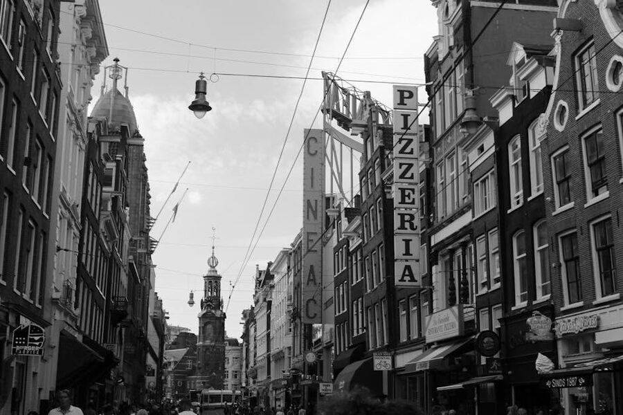 Black and white Amsterdam street with shop signage