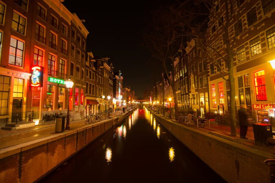 Amsterdam canal at night near the Red Light District with reflections