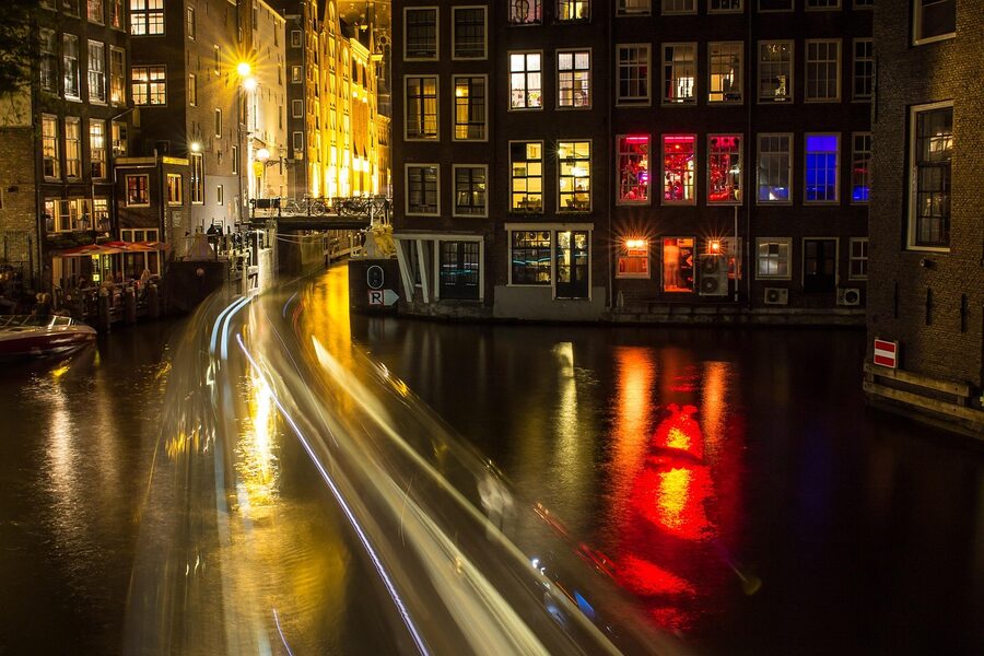 Amsterdam canal at night with light reflections