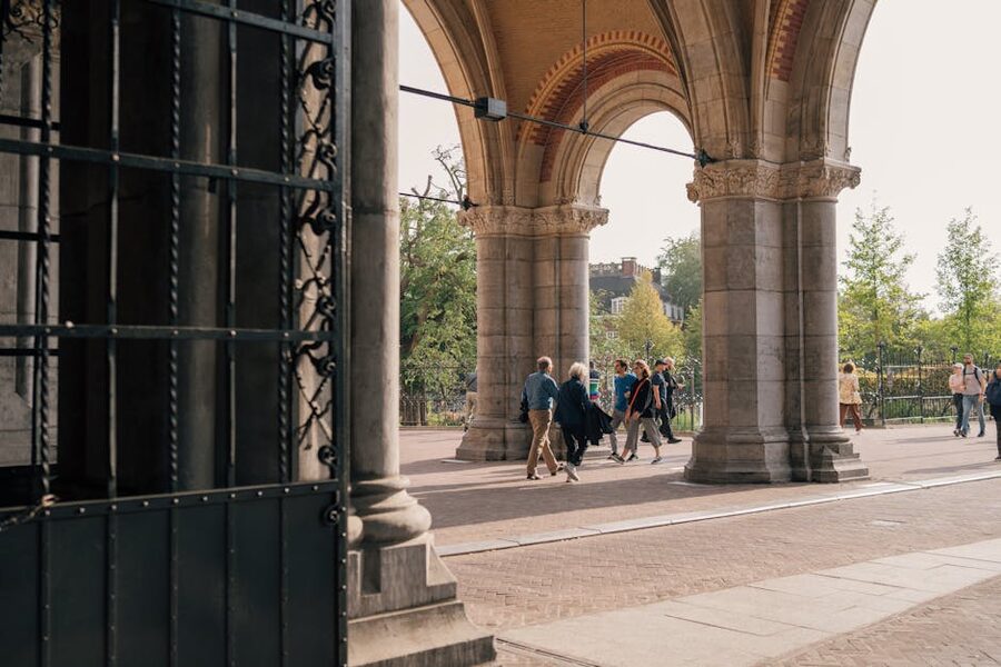 People walking through the Rijksmuseum passage arches Amsterdam