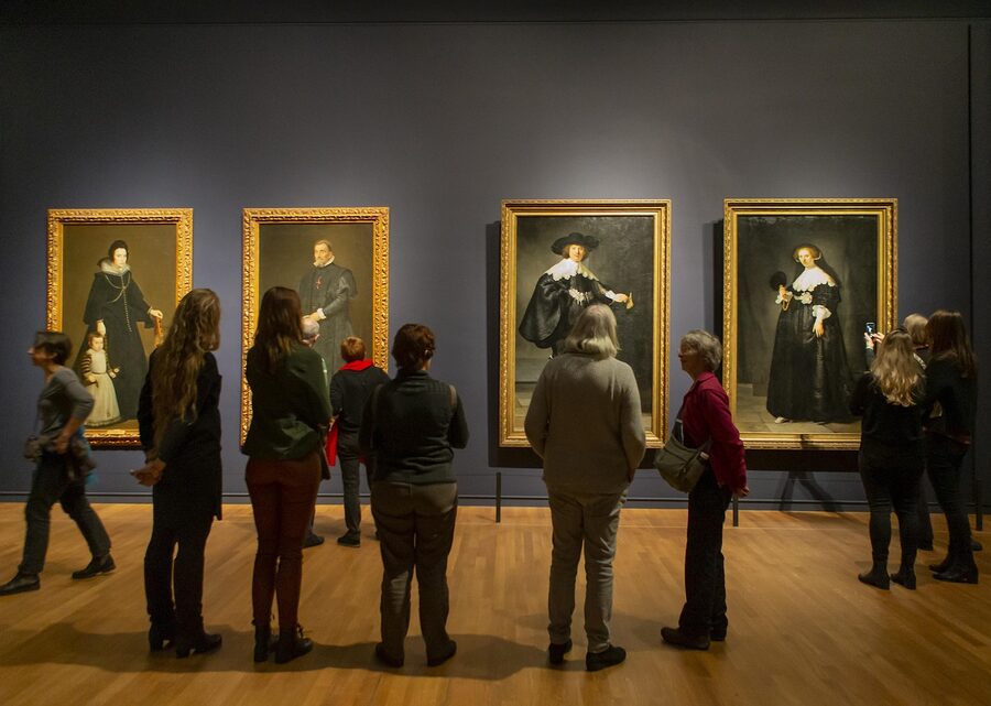 Visitors viewing paintings inside Rijksmuseum gallery