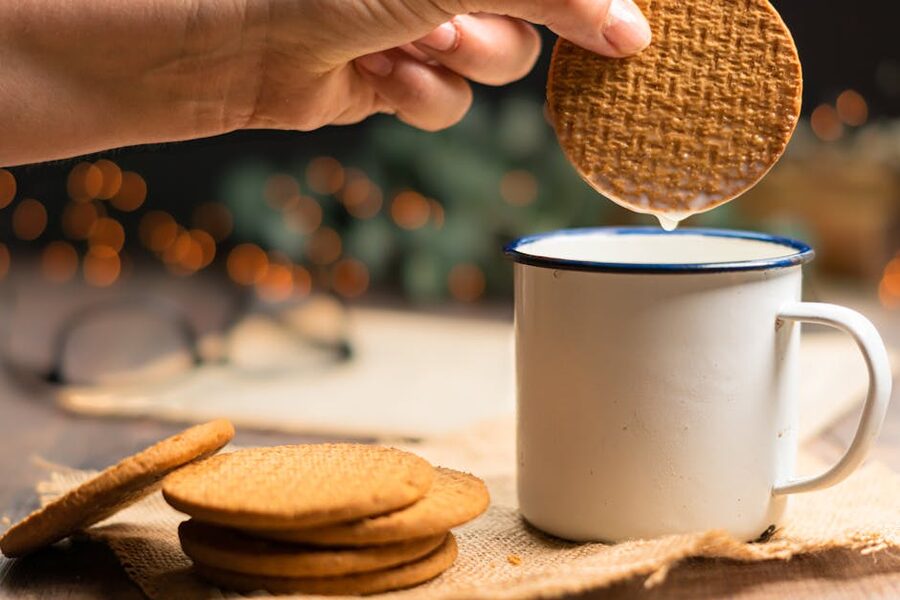Stroopwafel held over a cup of warm coffee