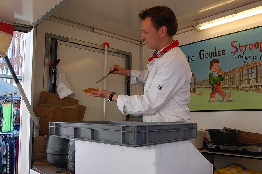 Slicing pressed stroopwafel horizontally Amsterdam