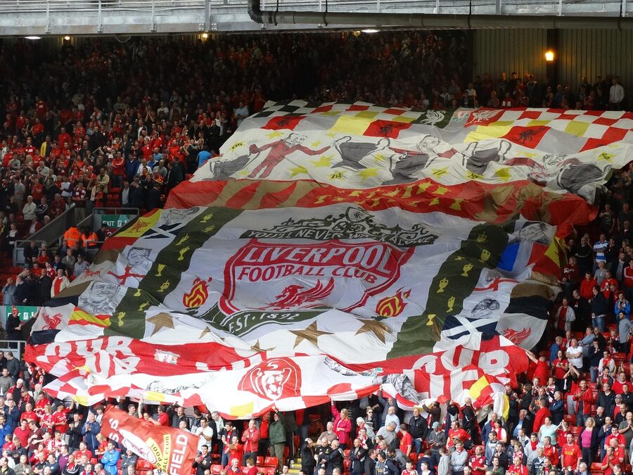 Liverpool fans holding huge flag at the Kop end during a match