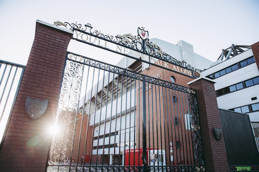 Iconic Shankly Gates at the entrance to Anfield Stadium with sun streaming through