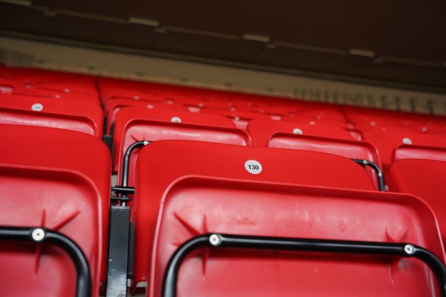 Numbered red Anfield Stadium seats close-up