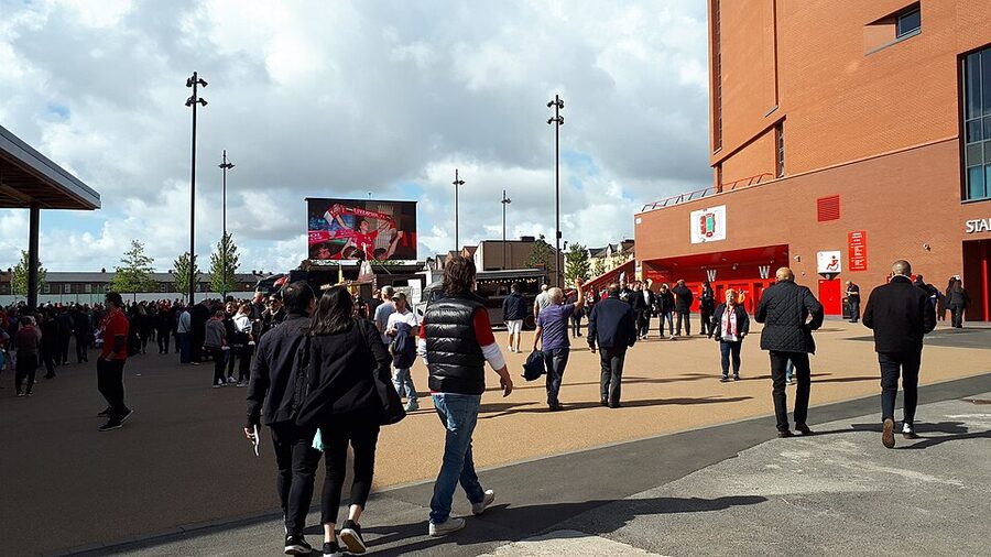 Pre-match fanzone outside Anfield Stadium with crowds and merch stalls