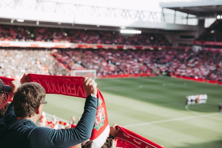 Liverpool football supporters with scarves at Anfield