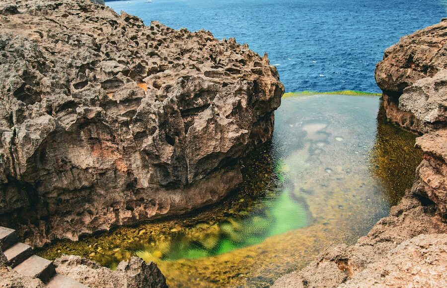 Angel's Billabong tidal rock pool on Nusa Penida spilling into the turquoise ocean through an infinity edge