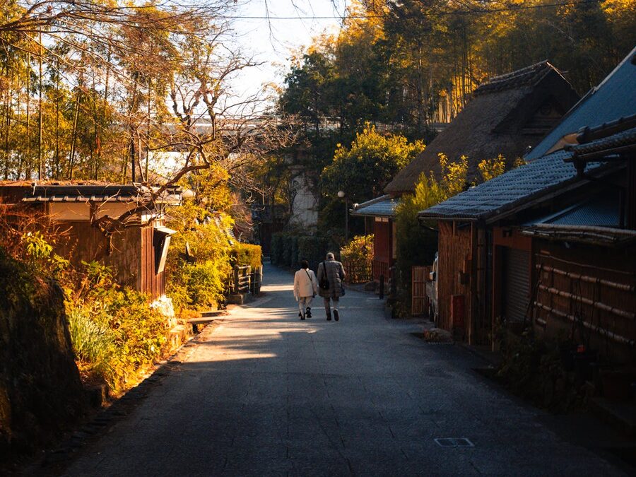 Quiet street in Arashiyama Kyoto at dusk with traditional houses and soft lighting