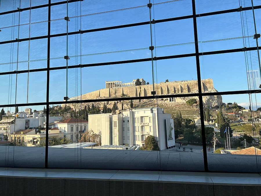 Acropolis Museum modern glass building with the Acropolis hill behind