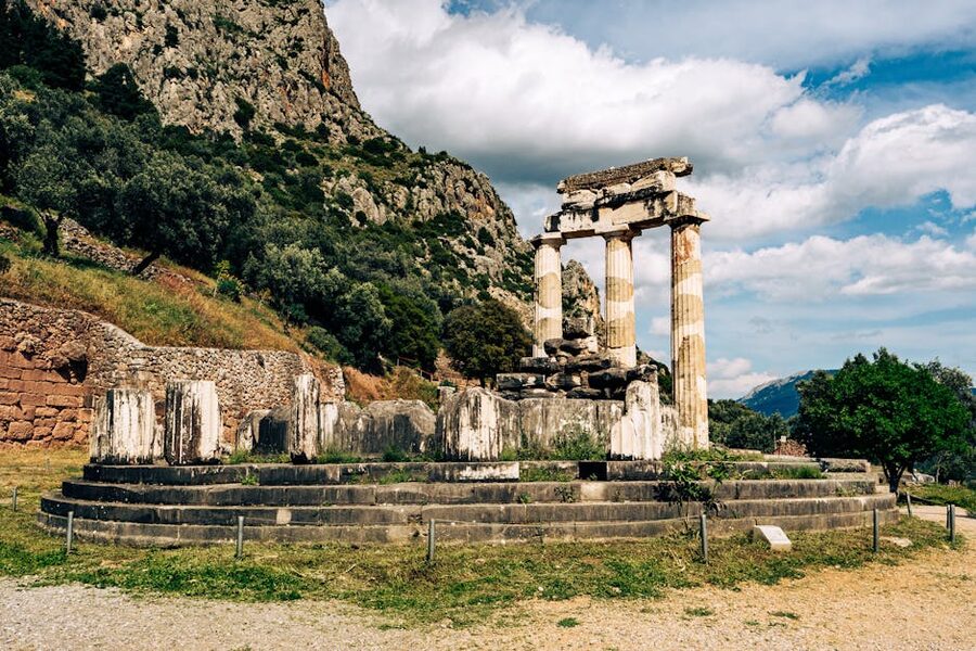 Ancient temple ruins Delphi mountain backdrop