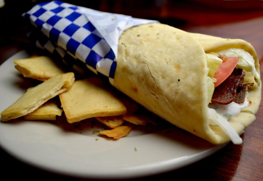 Greek gyro plate with sauce and salad
