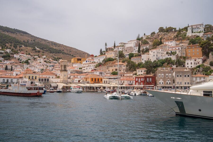 Hydra harbor yachts colorful houses Greek island