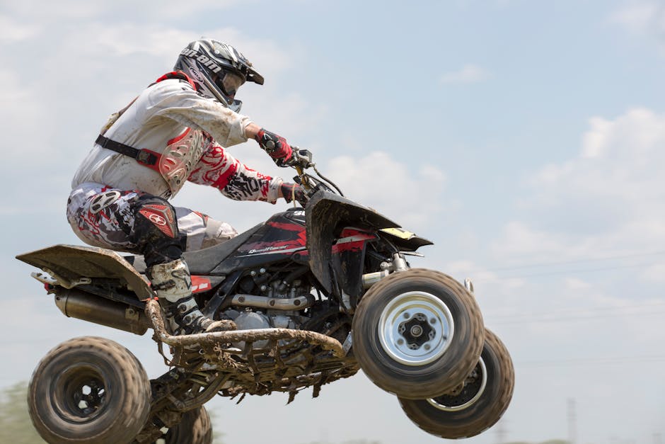 ATV rider airborne during a daytime action shot