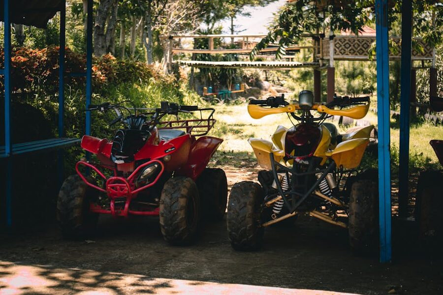 Quad bikes lined up at a shaded starting area