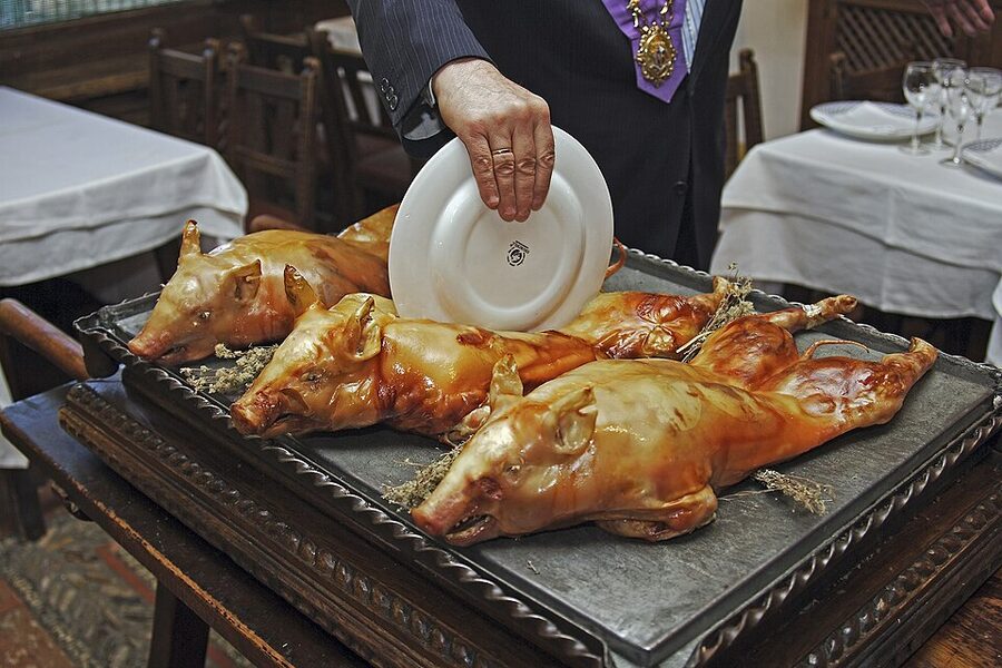 Cochinillo asado segoviano roast suckling pig on a plate