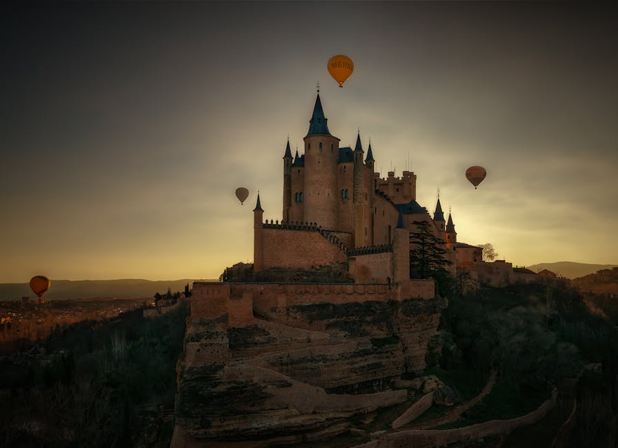 Alcazar of Segovia silhouetted against sunset with hot air balloons