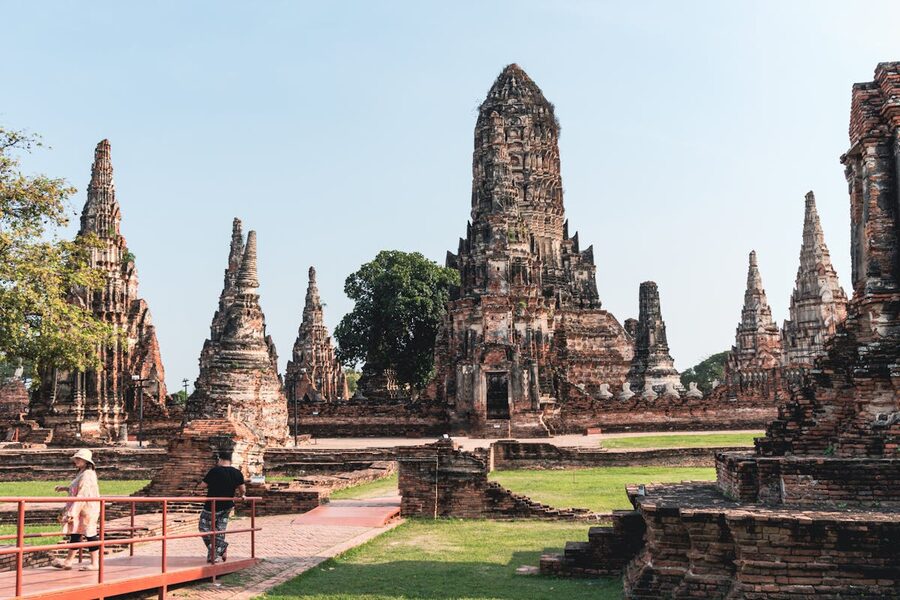 Ancient stone temple ruins of Wat Chaiwatthanaram against a blue sky in Ayutthaya Thailand
